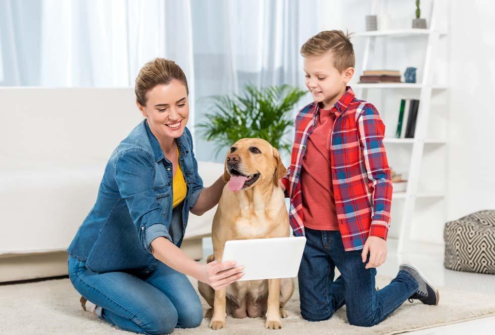 mother, son & dog looking at tablet - life insurance